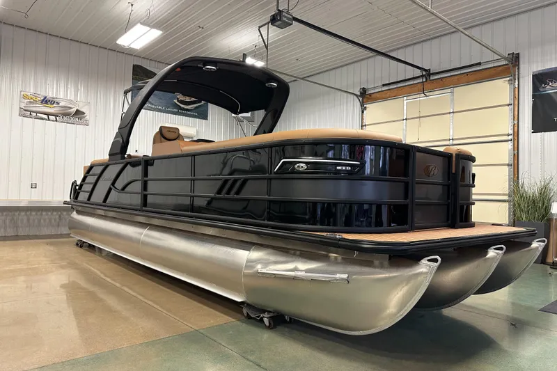 Slide: The Image of 2025 Bentley Pontoons Elite 253 Admiral in showroom, sleek design, luxury pontoon boat. - 11