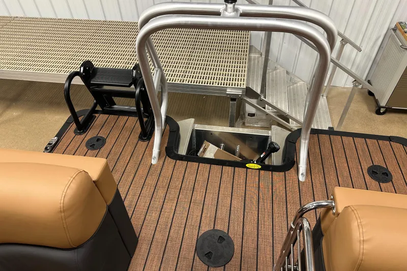 Slide: The Image of 2025 Bentley Pontoons Elite 253 Admiral interior with tan seats and wood-style flooring. - 14