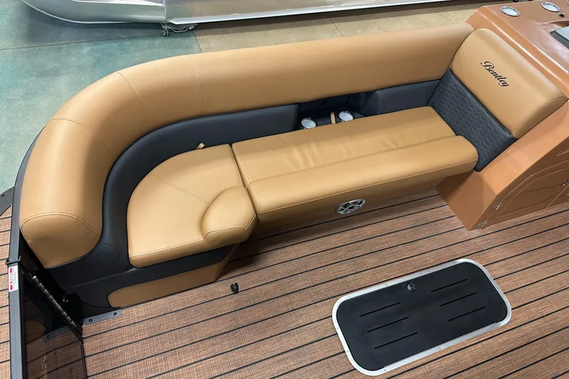 Slide: The Image of 2025 Bentley Pontoons Elite 253 Admiral interior with tan leather seating and wood flooring. - 17