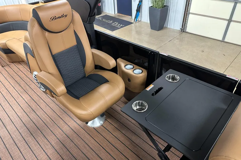 Slide: The Image of 2025 Bentley Pontoons Elite 253 Admiral interior with luxurious seating and table setup. - 23