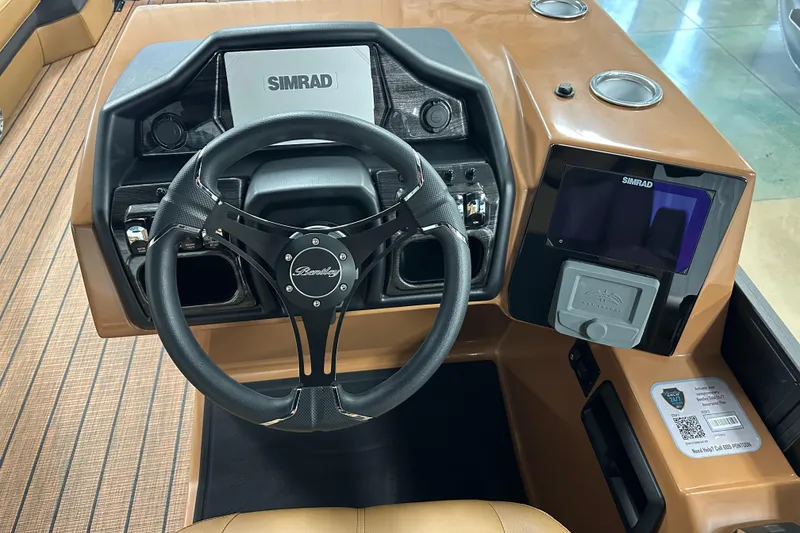 Slide: The Image of 2025 Bentley Pontoons Elite 253 Admiral dashboard with Simrad navigation system and sleek steering wheel. - 27