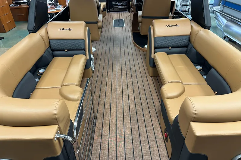 Slide: The Image of 2025 Bentley Pontoons Elite 253 Admiral interior with tan leather seating and wood flooring. - 28