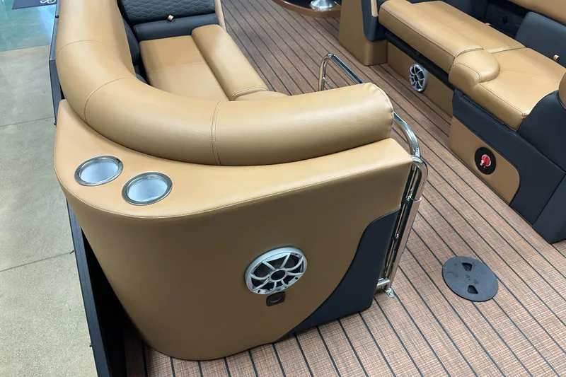 Slide: The Image of 2025 Bentley Pontoons Elite 253 Admiral interior with tan seating and cup holders. - 29