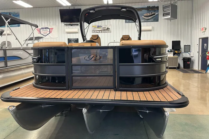 Slide: The Image of 2025 Bentley Pontoons Elite 253 Admiral in showroom, featuring sleek design and luxury seating. - 4
