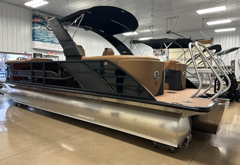 Slide: The Image of 2025 Bentley Pontoons Elite 253 Admiral in showroom, featuring sleek design and luxury seating. - 6