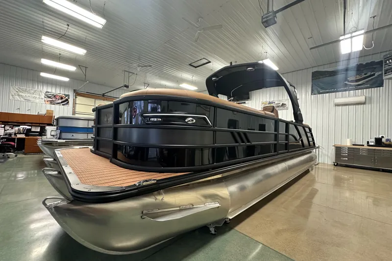 Slide: The Image of 2025 Bentley Pontoons Elite 253 Admiral in showroom, sleek design, luxury pontoon boat. - 8