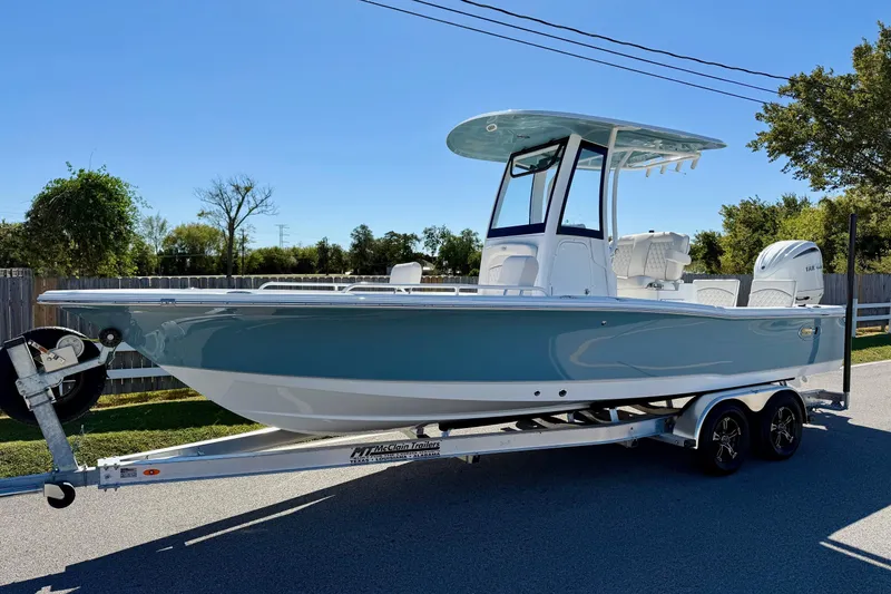The Image of 2026 Sea Hunt BX 25 FS boat on trailer, parked outdoors under clear sky. - 1