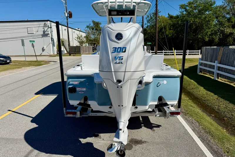 Slide: The Image of 2026 Sea Hunt BX 25 FS boat with 300 V6 engine on a sunny street. - 3