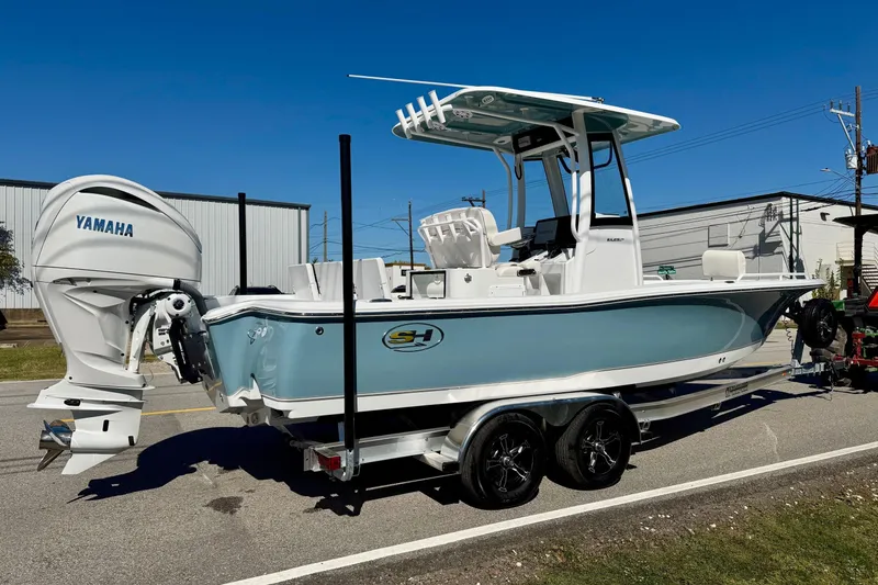 Slide: The Image of 2026 Sea Hunt BX 25 FS boat with Yamaha engine on trailer, parked outdoors. - 4