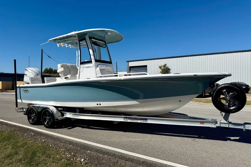 Slide: The Image of 2026 Sea Hunt BX 25 FS boat on trailer, parked outdoors under clear blue sky. - 5