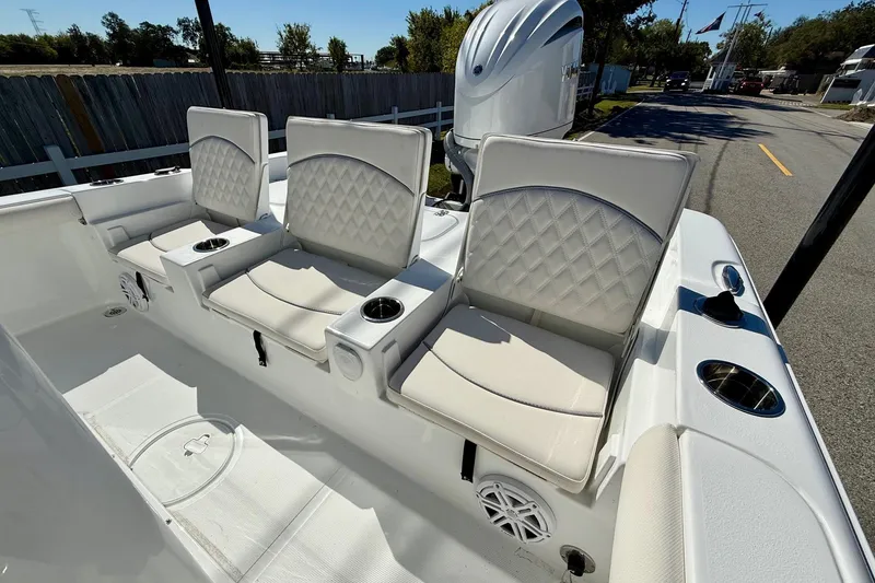 Slide: The Image of 2026 Sea Hunt BX 25 FS boat with three cushioned seats and cup holders. - 7
