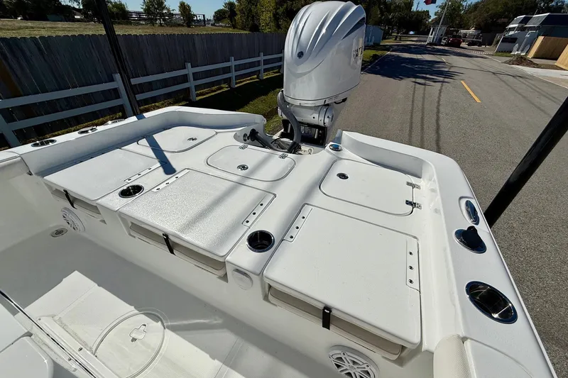 Slide: The Image of 2026 Sea Hunt BX 25 FS boat deck with storage compartments and outboard motor. - 8