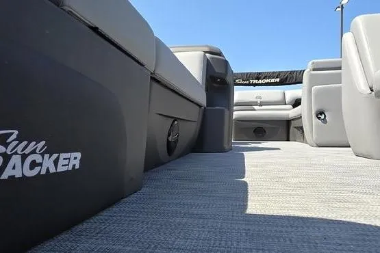 Slide: The Image of 2026 Sun Tracker PB 20 DLX pontoon boat interior with gray seating and carpet. - 13