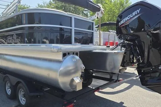Slide: The Image of 2026 Sun Tracker PB 20 DLX pontoon boat with Mercury outboard motor on trailer. - 5