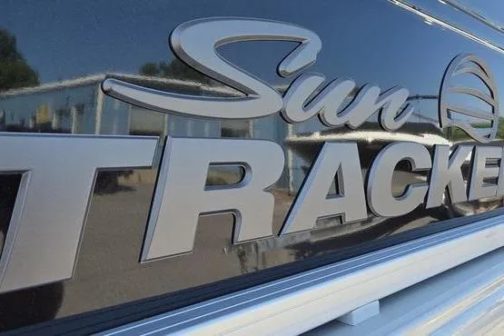 Slide: The Image of Close-up of 2026 Sun Tracker PB 20 DLX logo on a shiny surface. - 7