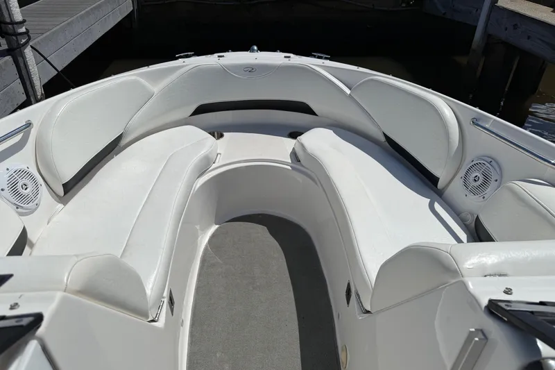 Slide: The Image of 2007 Regal 2400 Bowrider boat with white seating and sleek design. - 3
