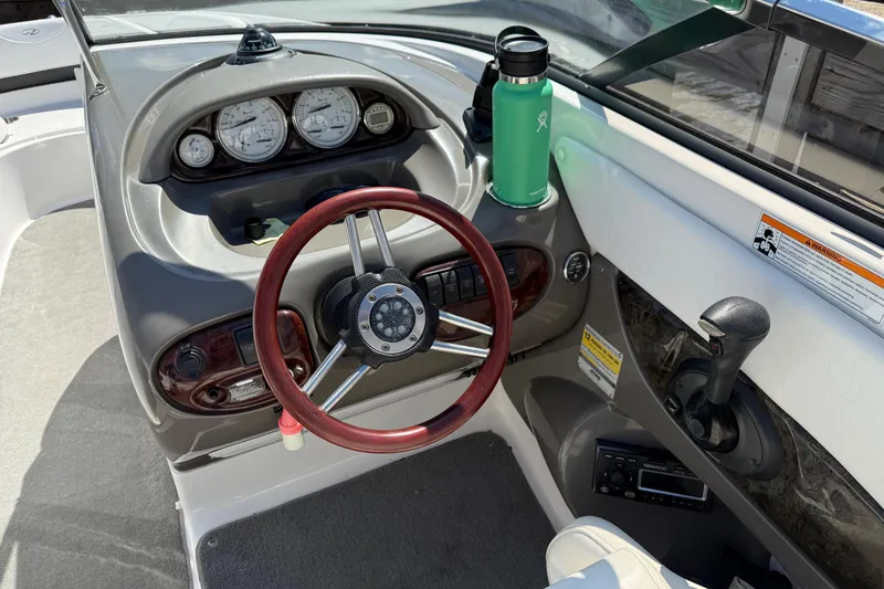 Slide: The Image of 2007 Regal 2400 Bowrider boat interior with white seating and speakers. - 4