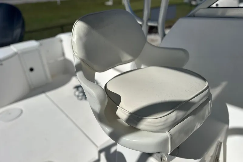 Slide: The Image of White captain's chair on 2000 Cobia 240 Walkaround boat deck. - 5