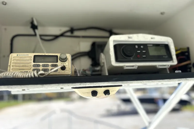 Slide: The Image of Electronics on a 2000 Cobia 240 Walkaround boat, featuring a radio and control panel. - 8