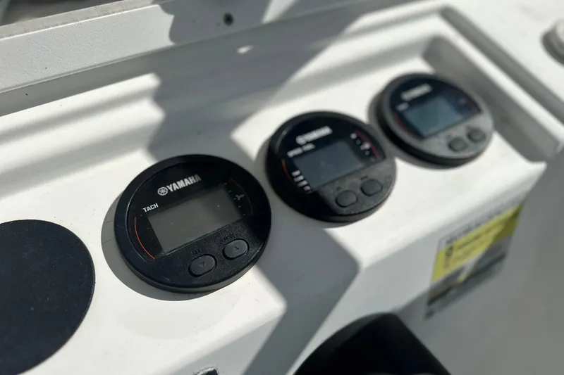 Slide: The Image of Yamaha gauges on a 2000 Cobia 240 Walkaround boat dashboard. - 9