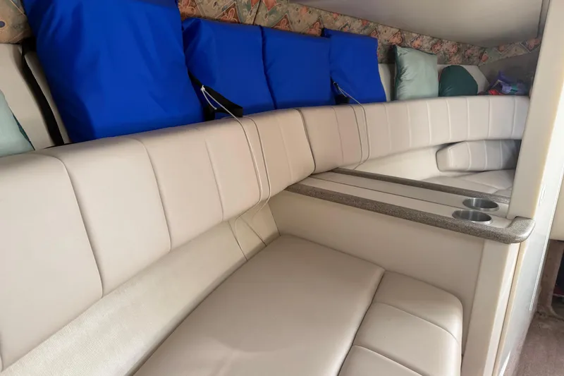 Slide: The Image of Interior of 2000 Formula 280 Sun Sport boat with beige seating and blue cushions. - 11