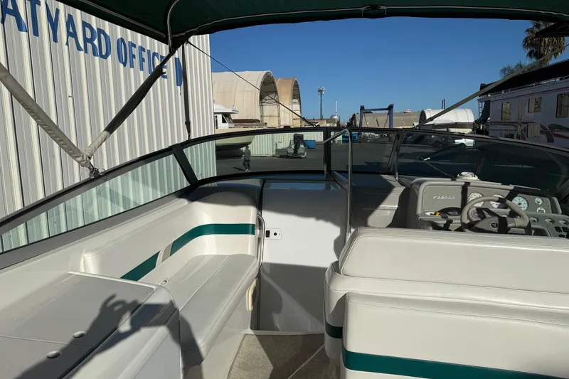 Slide: The Image of 2000 Formula 280 Sun Sport boat interior at a boatyard, featuring seating and dashboard. - 13