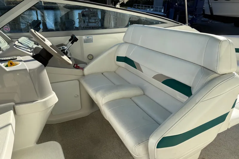 Slide: The Image of Interior of a 2000 Formula 280 Sun Sport boat with white seating and steering wheel. - 15
