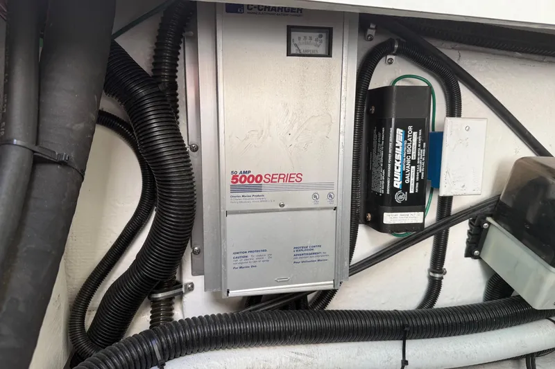 Slide: The Image of Electrical components in a 2000 Formula 280 Sun Sport boat, featuring a 50 AMP charger. - 28
