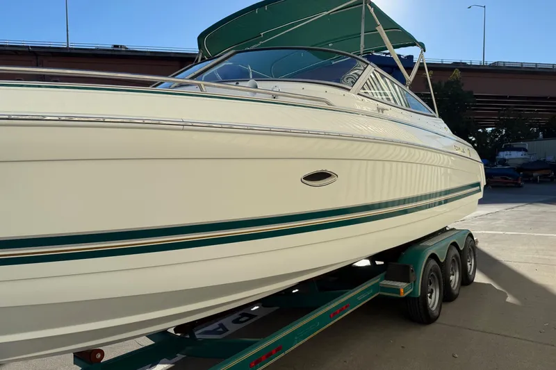 Slide: The Image of 2000 Formula 280 Sun Sport boat on trailer, under a bridge, with green accents. - 4