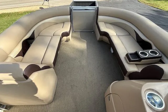 Slide: The Image of 2014 Harris FloteBote Sunliner 200 interior with beige seating and cup holders. - 12