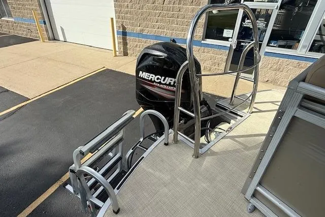 Slide: The Image of 2014 Harris FloteBote Sunliner 200 with Mercury outboard motor, docked at a marina. - 19