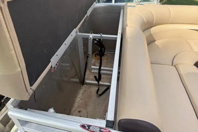 Slide: The Image of 2014 Harris FloteBote Sunliner 200 storage compartment with beige seating and open hatch. - 20