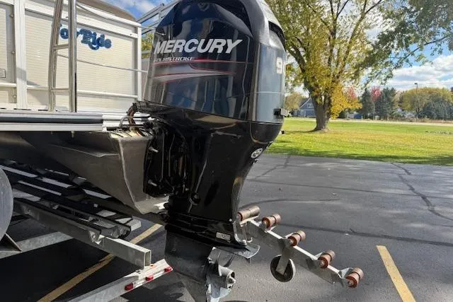 Slide: The Image of 2014 Harris FloteBote Sunliner 200 with Mercury outboard motor on trailer. - 22