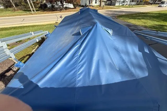 Slide: The Image of Covered 2014 Harris FloteBote Sunliner 200 pontoon boat with blue tarp on trailer. - 28