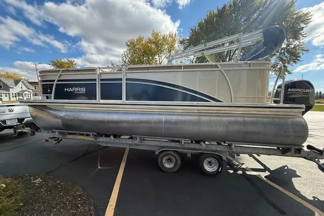 Slide: The Image of 2014 Harris FloteBote Sunliner 200 pontoon boat on trailer under blue sky. - 3