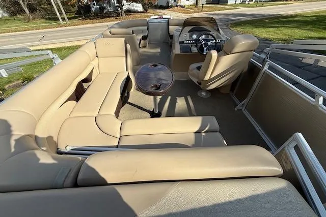 Slide: The Image of 2014 Harris FloteBote Sunliner 200 pontoon boat interior with beige seating and steering console. - 4