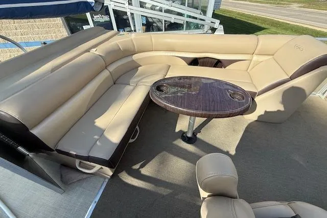 Slide: The Image of 2014 Harris FloteBote Sunliner 200 interior with beige seating and round table. - 5