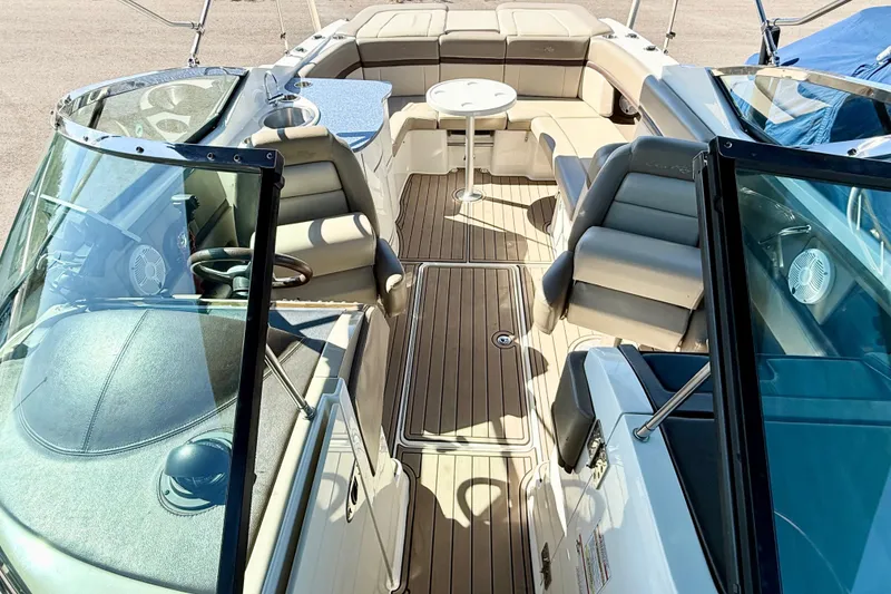 Slide: The Image of 2011 Sea Ray 270 SLX boat interior with beige seating and open windshield. - 14