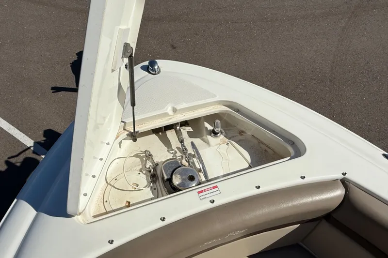 Slide: The Image of 2011 Sea Ray 270 SLX boat interior with sink, countertop, and storage compartments. - 16