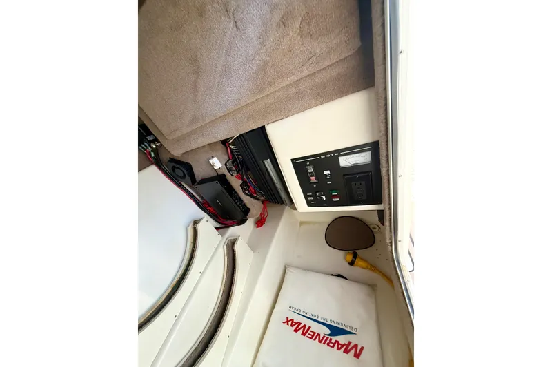 Slide: The Image of 2011 Sea Ray 270 SLX boat interior with beige seating and open windshield. - 21