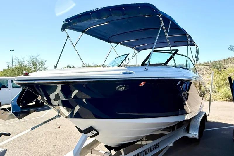 Slide: The Image of 2011 Sea Ray 270 SLX boat on trailer, featuring blue and white design with canopy. - 4