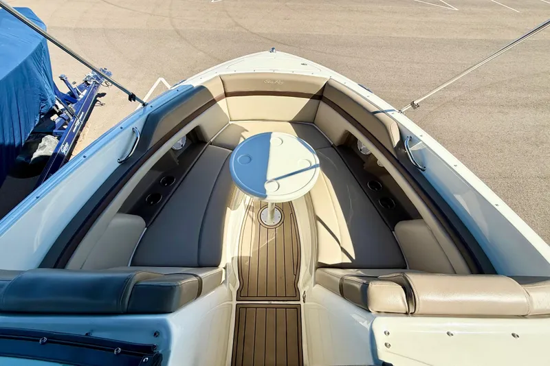 Slide: The Image of 2011 Sea Ray 270 SLX boat interior with seating, table, and helm. - 9