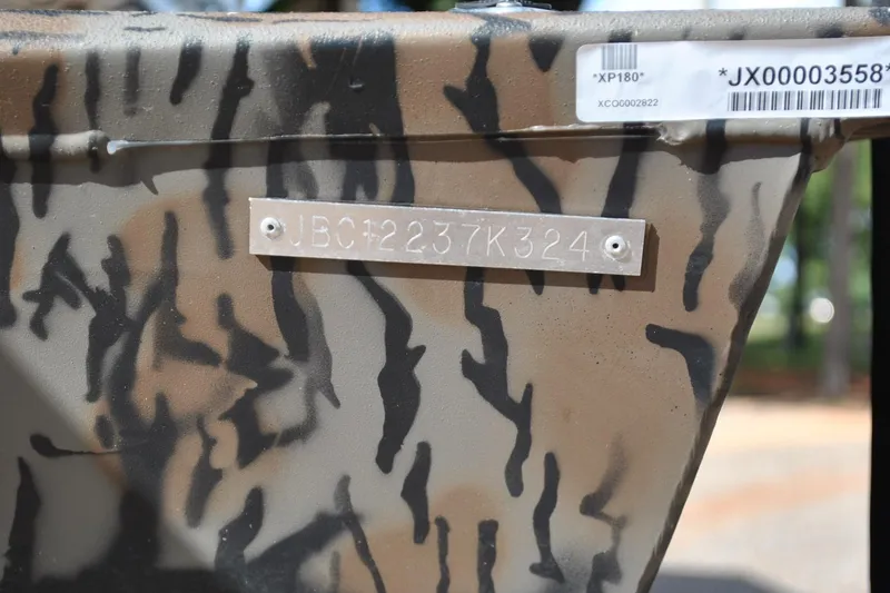 Slide: The Image of 2024 Express 180XP boat with camouflage pattern and visible identification plate. - 10