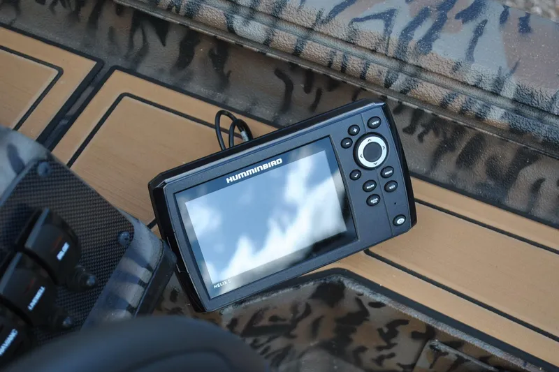 Slide: The Image of Fishfinder device on 2024 Express 180XP boat with camouflage interior design. - 18