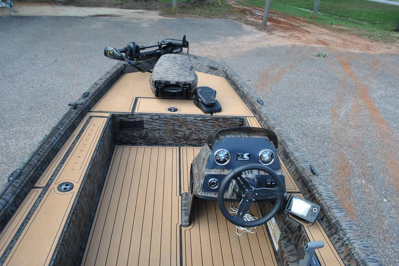 Slide: The Image of 2024 Express 180XP boat interior with steering console and camo design. - 20
