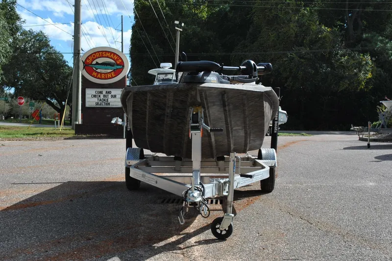 Slide: The Image of 2024 Express 180XP boat on trailer at Sportsman's Marine dealership. - 3