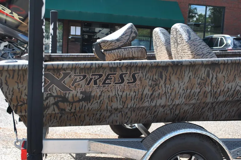 Slide: The Image of 2024 Express 180XP boat with camouflage design on a trailer. - 8