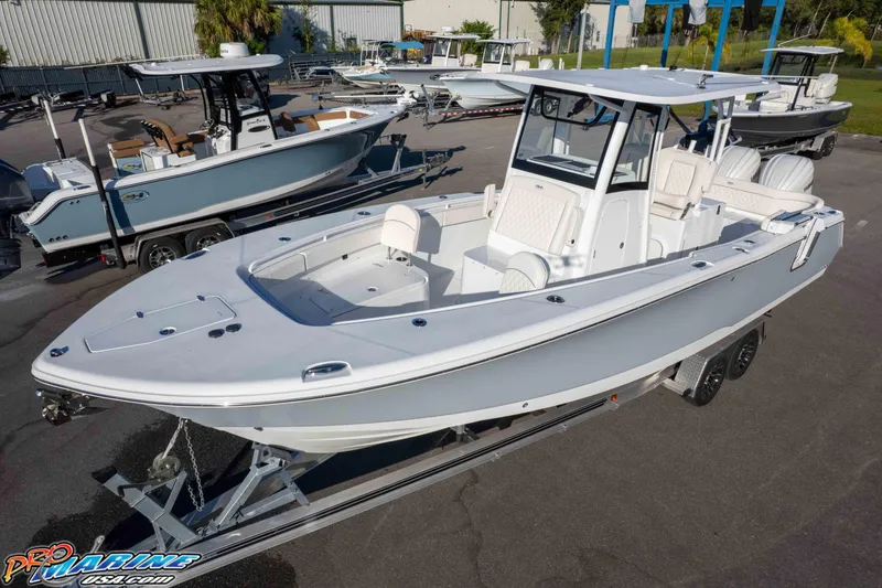 Slide: The Image of 2026 Sea Hunt Ultra 285 SE boat on trailer in marina setting. - 11