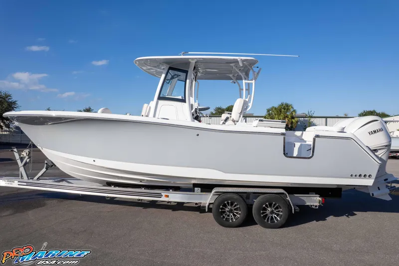 Slide: The Image of 2026 Sea Hunt Ultra 285 SE boat on trailer, side view, clear sky background. - 13