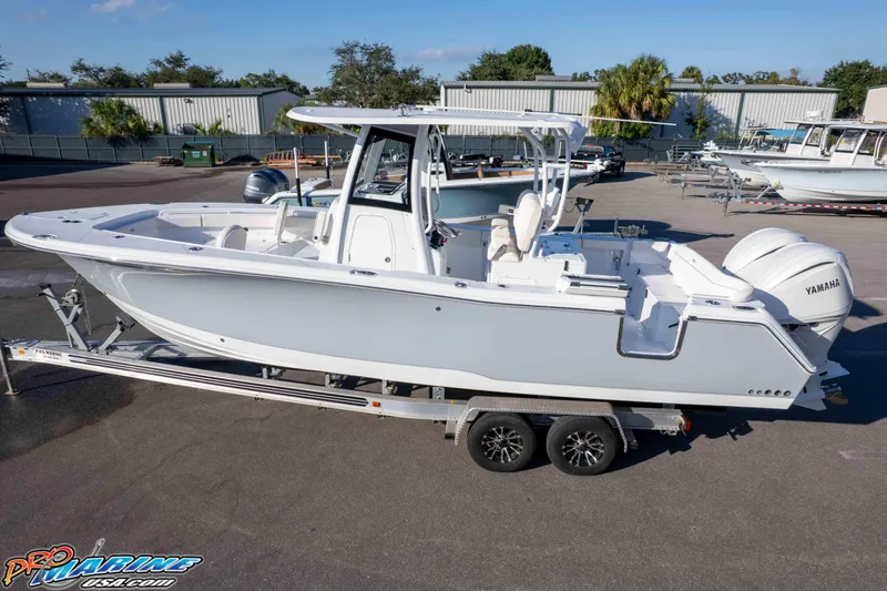 Slide: The Image of 2026 Sea Hunt Ultra 285 SE boat on trailer, featuring Yamaha engines, in a marina setting. - 15